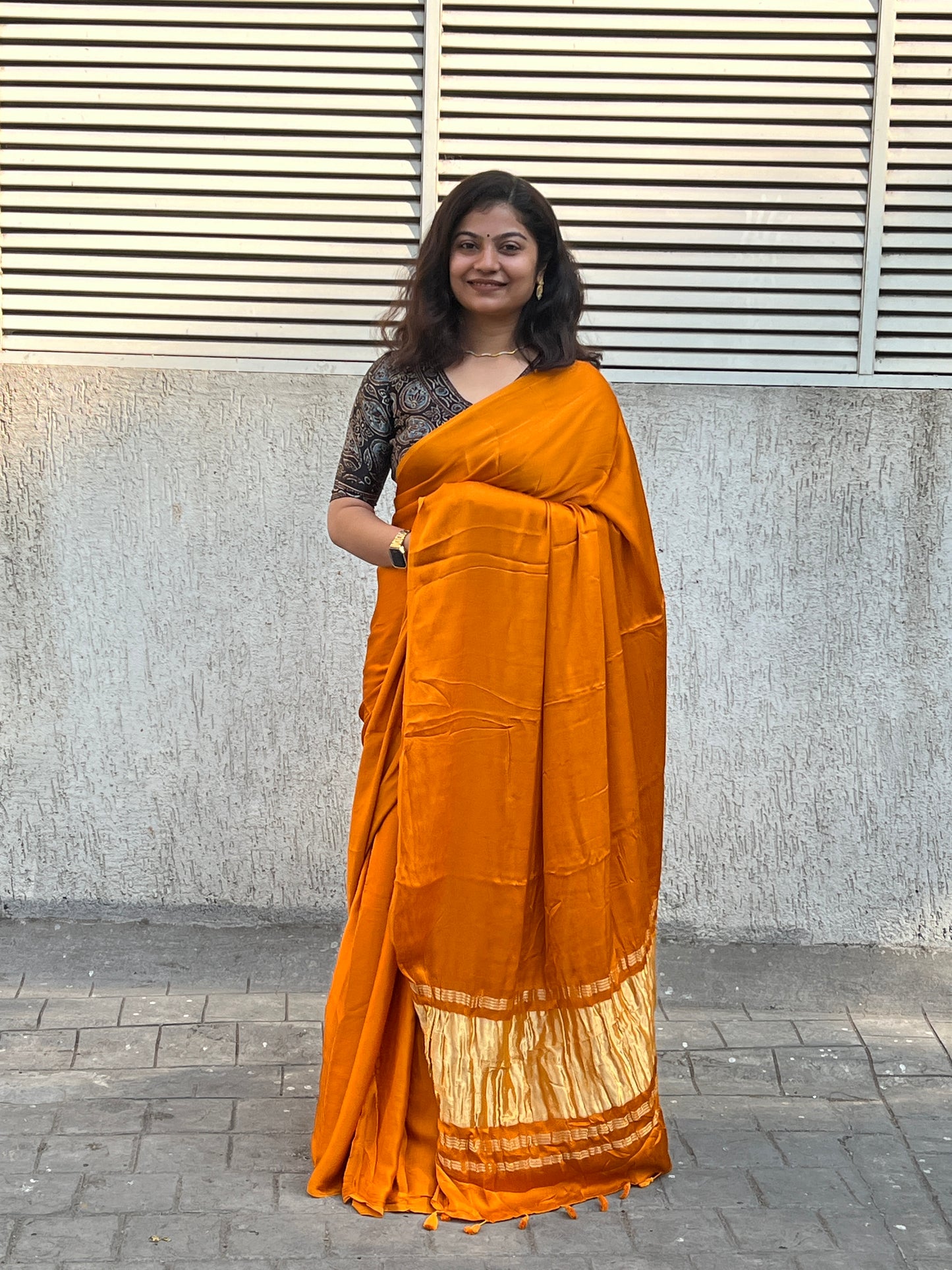 Orange plain modal silk saree with tissue border