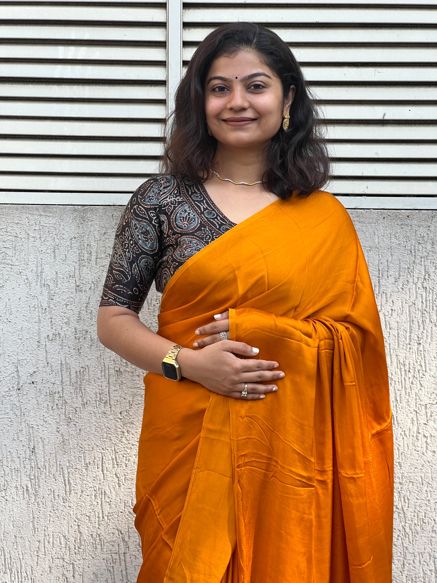 Orange plain modal silk saree with tissue border