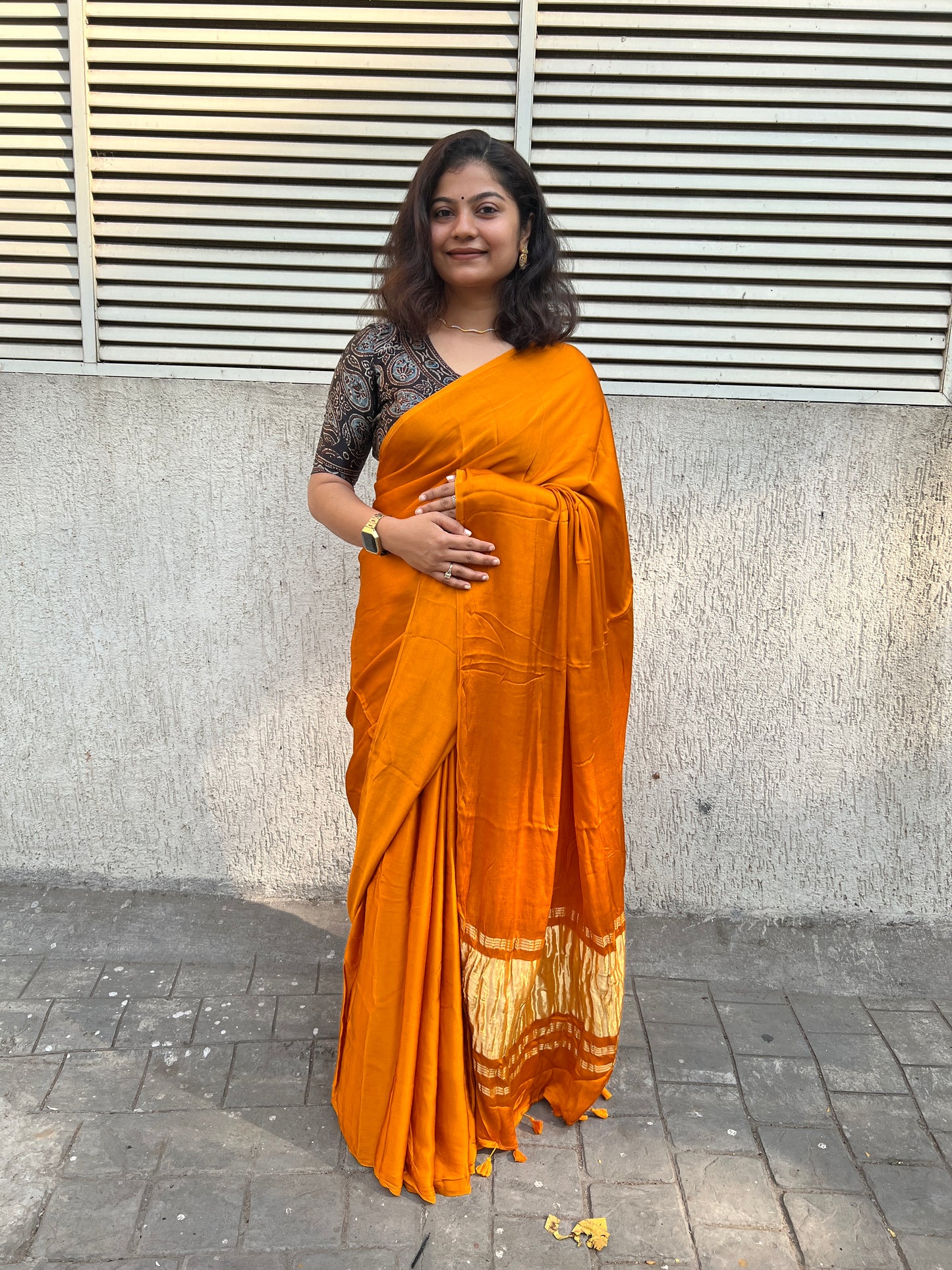 Orange plain modal silk saree with tissue border