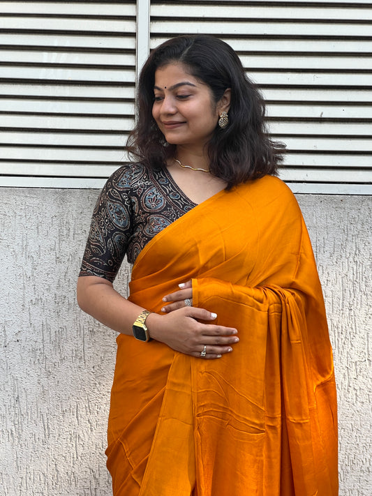 Orange plain modal silk saree with tissue border